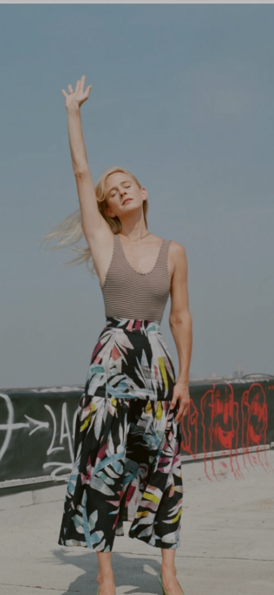 Andrea Powell photographed for Vogue's Mara Hoffman × Art Not War series, arm raised